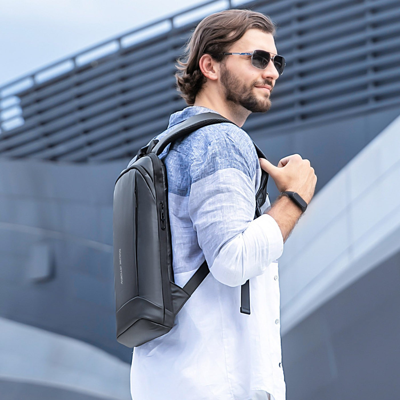Man with Mark Ryden lightweight and waterproof USB charging backpack - Blend. 